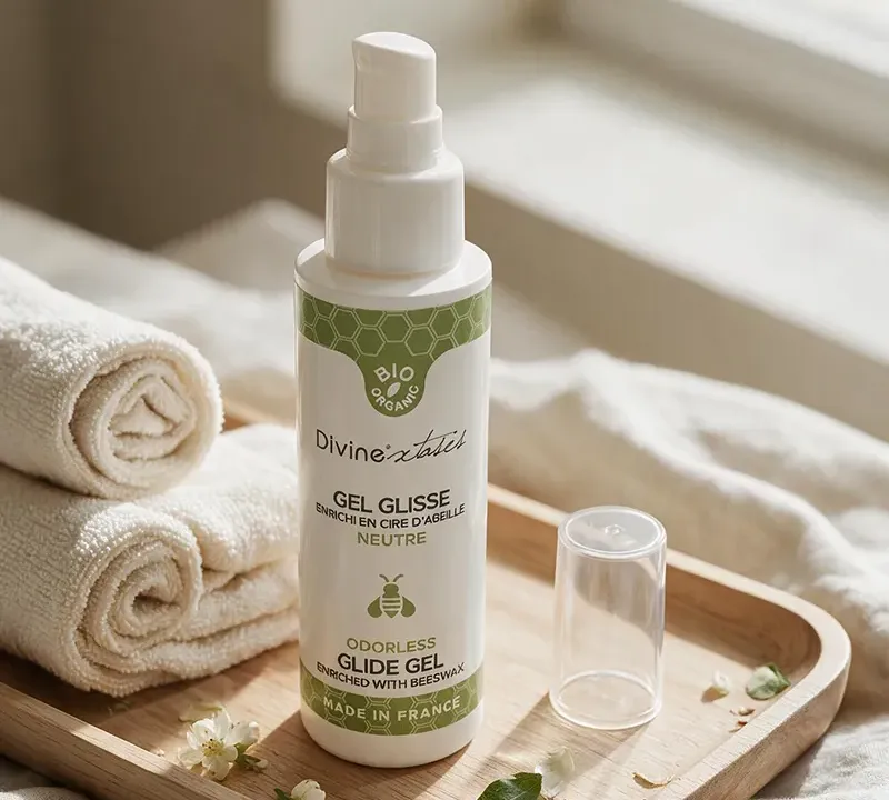 Flacon de lubrifiant intime naturel posé sur un plateau avec des serviettes de bain